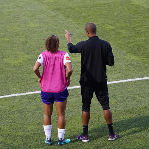 Soccer player and coach on field